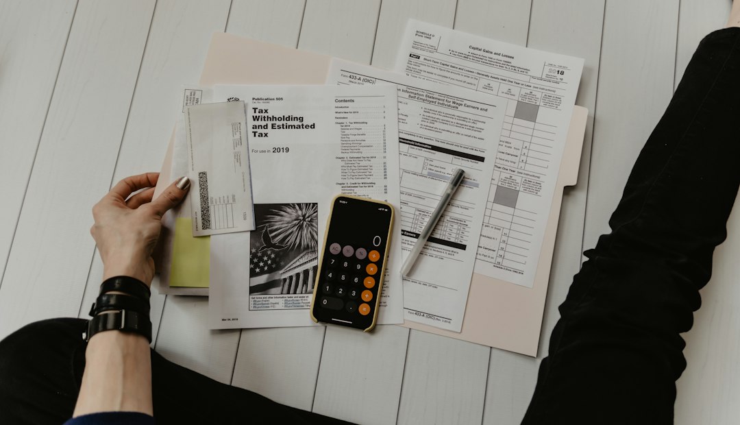 A pen and calculator resting on printed financial statements during a spend review