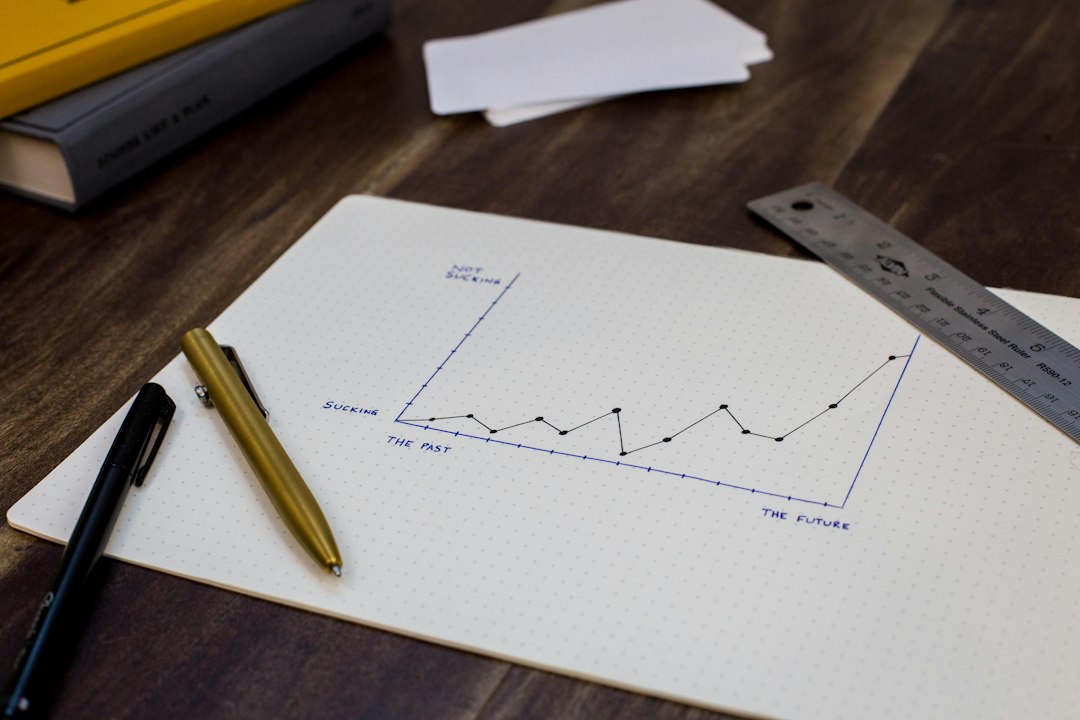 Printed growth charts on a desk with a pen resting on the pages