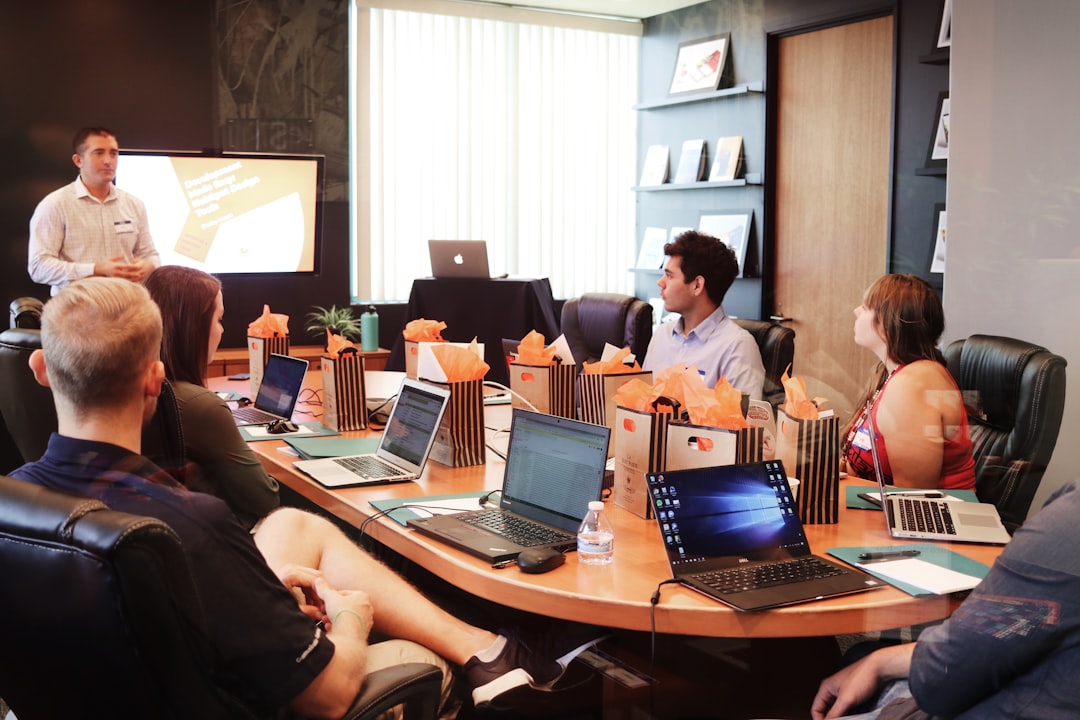 A marketing leader presenting quarterly performance numbers to a team seated at a conference table